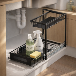 Sinkly organiser installed under a kitchen sink, loaded with cleaning supplies and pulled out around the drain pipe